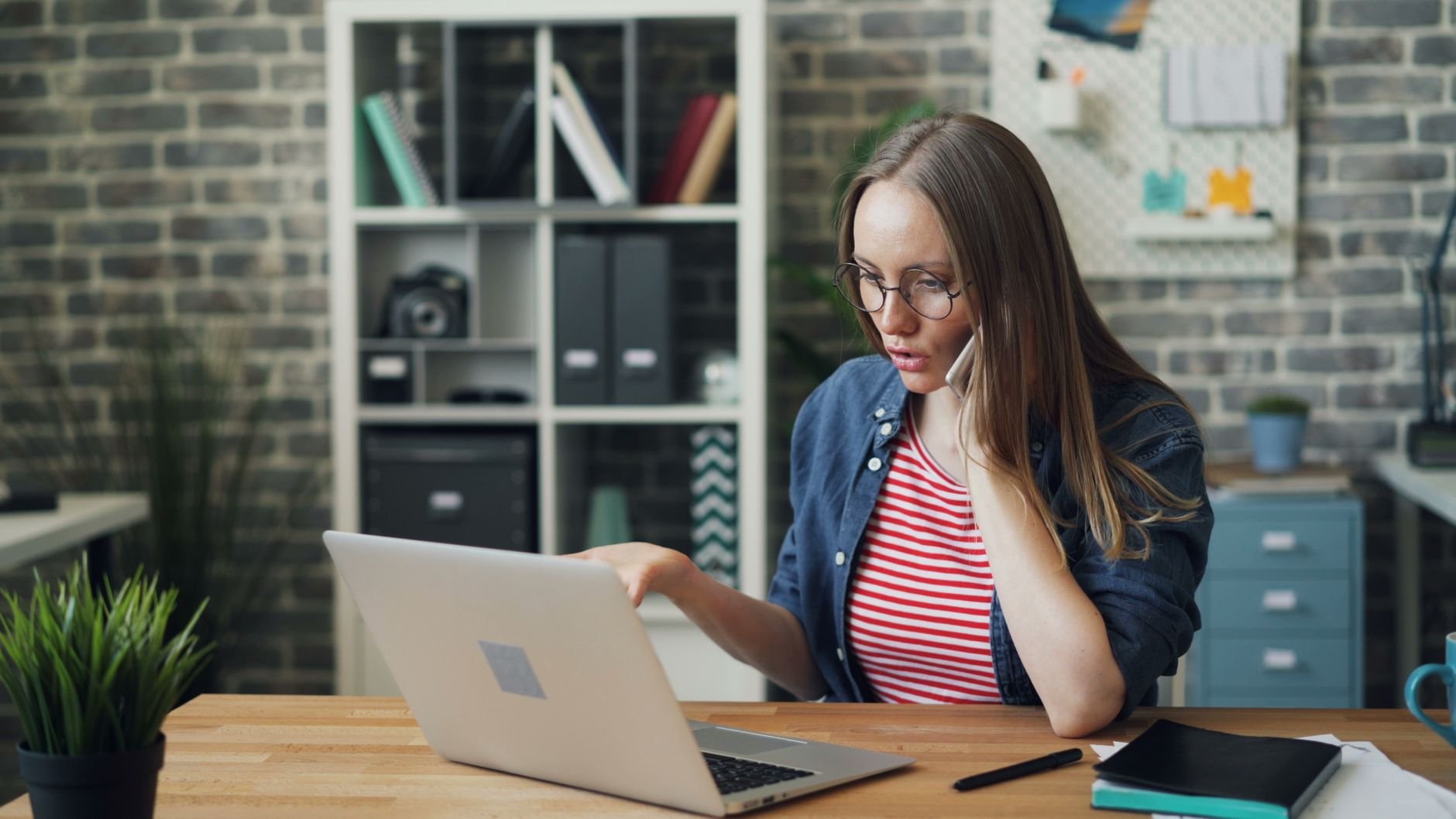 Solo entrepreneur focused on work at a laptop in a modern office